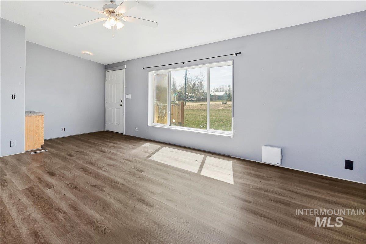 501 Timber Avenue Fairfield, ID 83327 - Photo 4 of 27 Unfurnished room featuring ceiling fan and dark wood finished floors