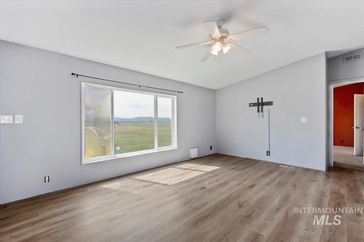 501 Timber Avenue Fairfield, ID 83327 - Photo 6 of 27 Unfurnished room with a ceiling fan and light wood-type flooring