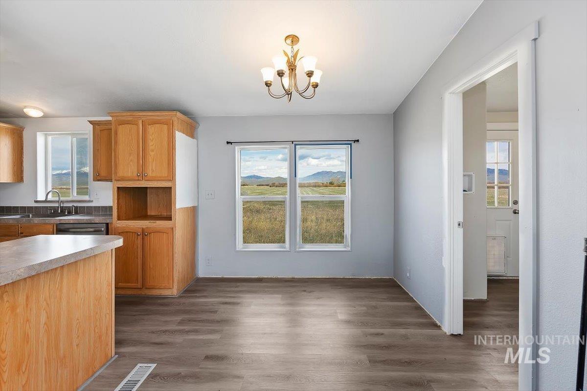 501 Timber Avenue Fairfield, ID 83327 - Photo 8 of 27 Dining space featuring dark wood-style flooring and suspended lighting