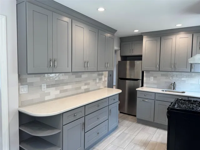 a kitchen with a sink appliances and cabinets