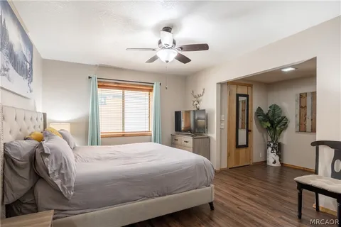 a bedroom with a large bed and a chandelier