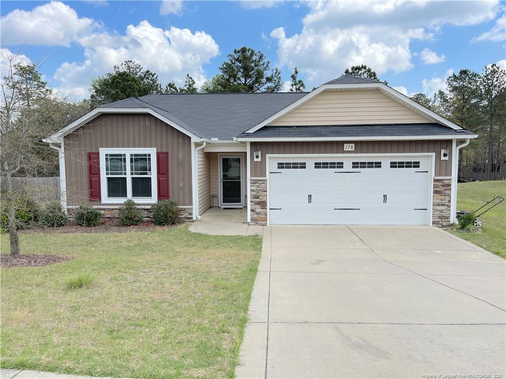 a front view of a house with a yard and garage