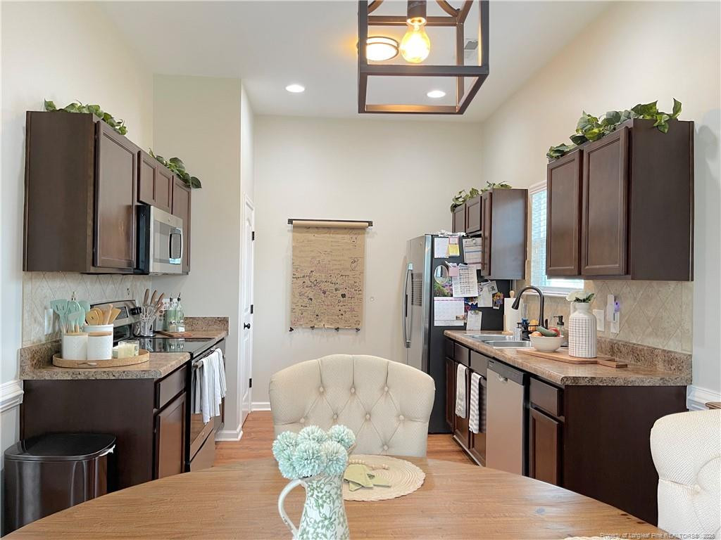 178 Angel Oak Drive Bunnlevel, NC 28323 - Photo 6 of 15 a kitchen with a sink stove and microwave