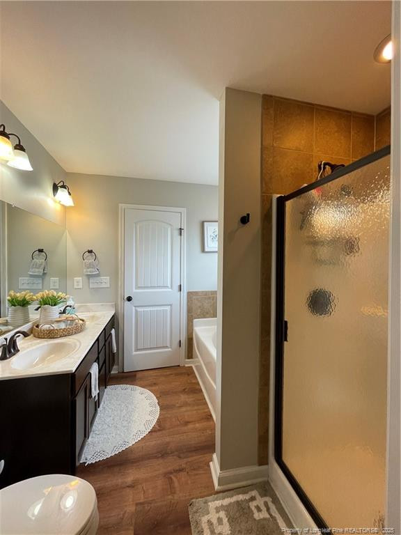 178 Angel Oak Drive Bunnlevel, NC 28323 - Photo 9 of 15 a large bathroom with a granite countertop sink a toilet a mirror and shower