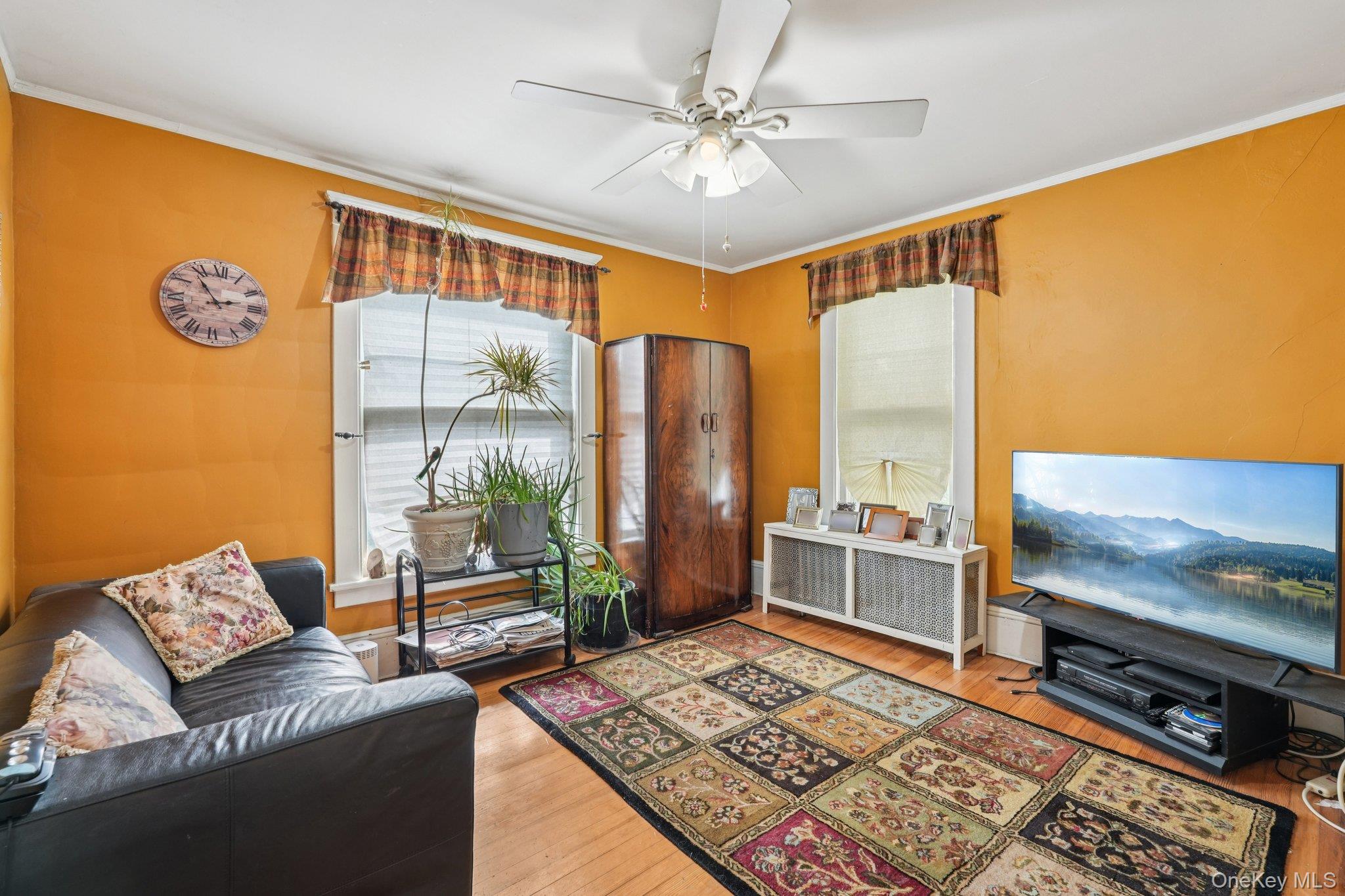 74 East Maple Avenue Suffern, NY 10901 - Photo 29 of 50 Living area with ornamental molding, radiator, hardwood / wood-style floors, and a ceiling fan