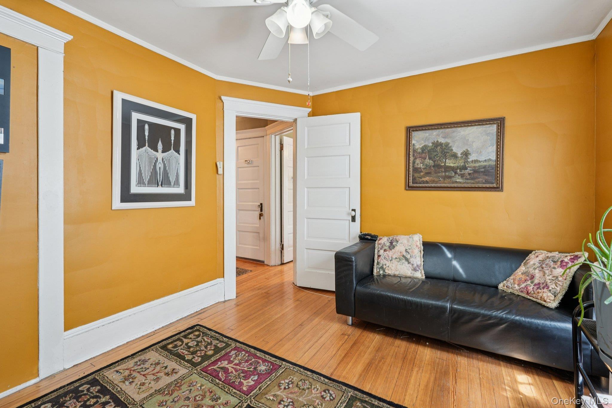 74 East Maple Avenue Suffern, NY 10901 - Photo 30 of 50 Living room featuring crown molding, hardwood / wood-style flooring, and a ceiling fan