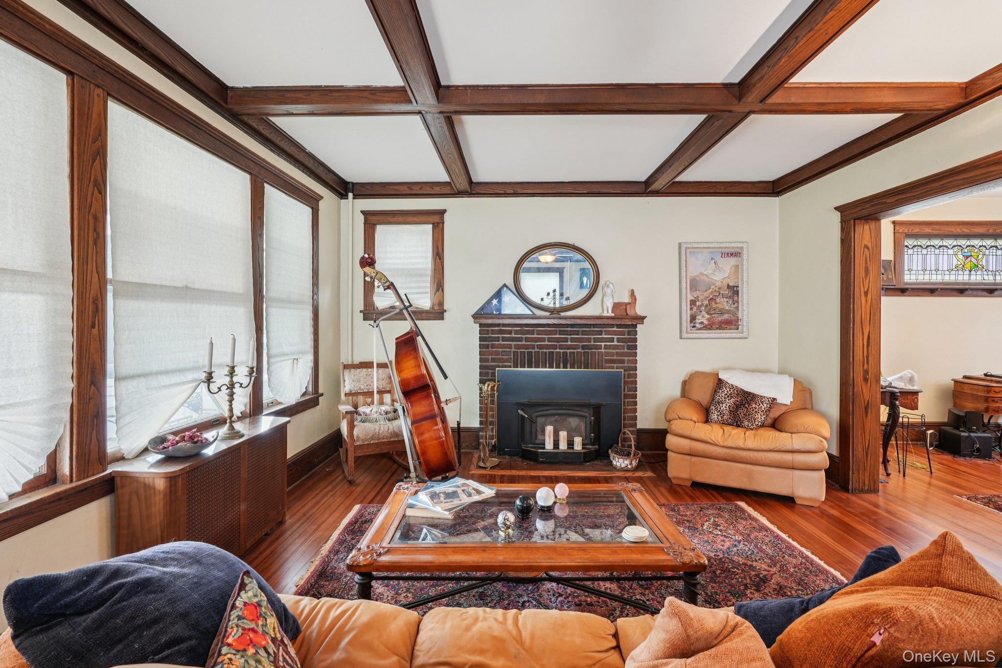 74 East Maple Avenue Suffern, NY 10901 - Photo 5 of 50 Living room featuring coffered ceiling, beamed ceiling, wood finished floors, and a wood stove