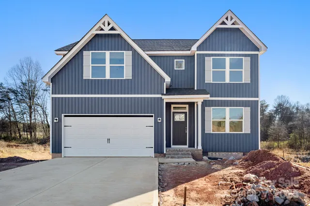 a view of a house with a yard and garage
