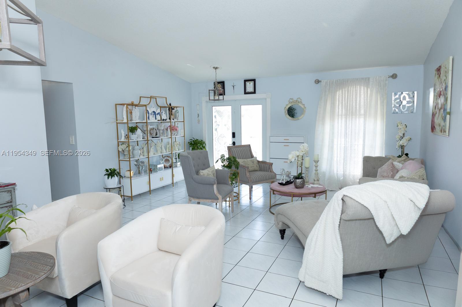 15201 Southwest 177th Terrace Miami, FL 33187 - Photo 15 of 49 a living room with furniture and a large window