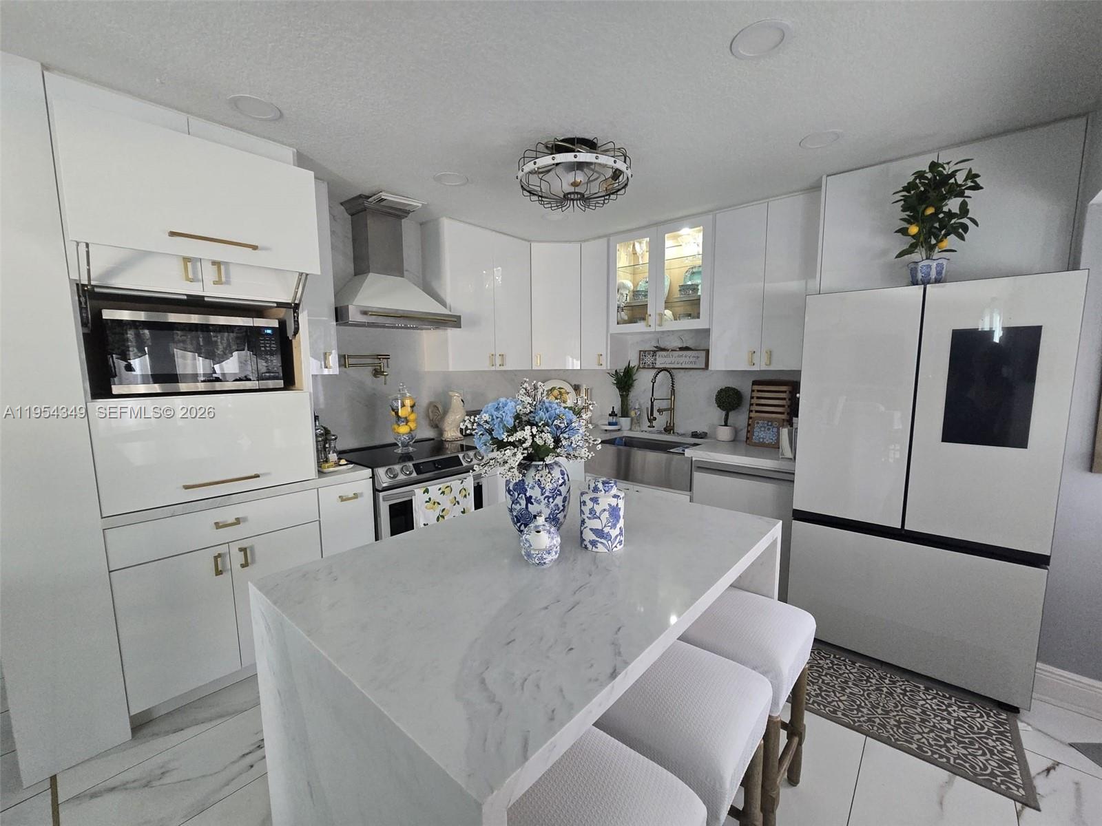 15201 Southwest 177th Terrace Miami, FL 33187 - Photo 27 of 49 a kitchen with stainless steel appliances granite countertop a refrigerator a sink dishwasher a stove a dining table and chairs with wooden floor
