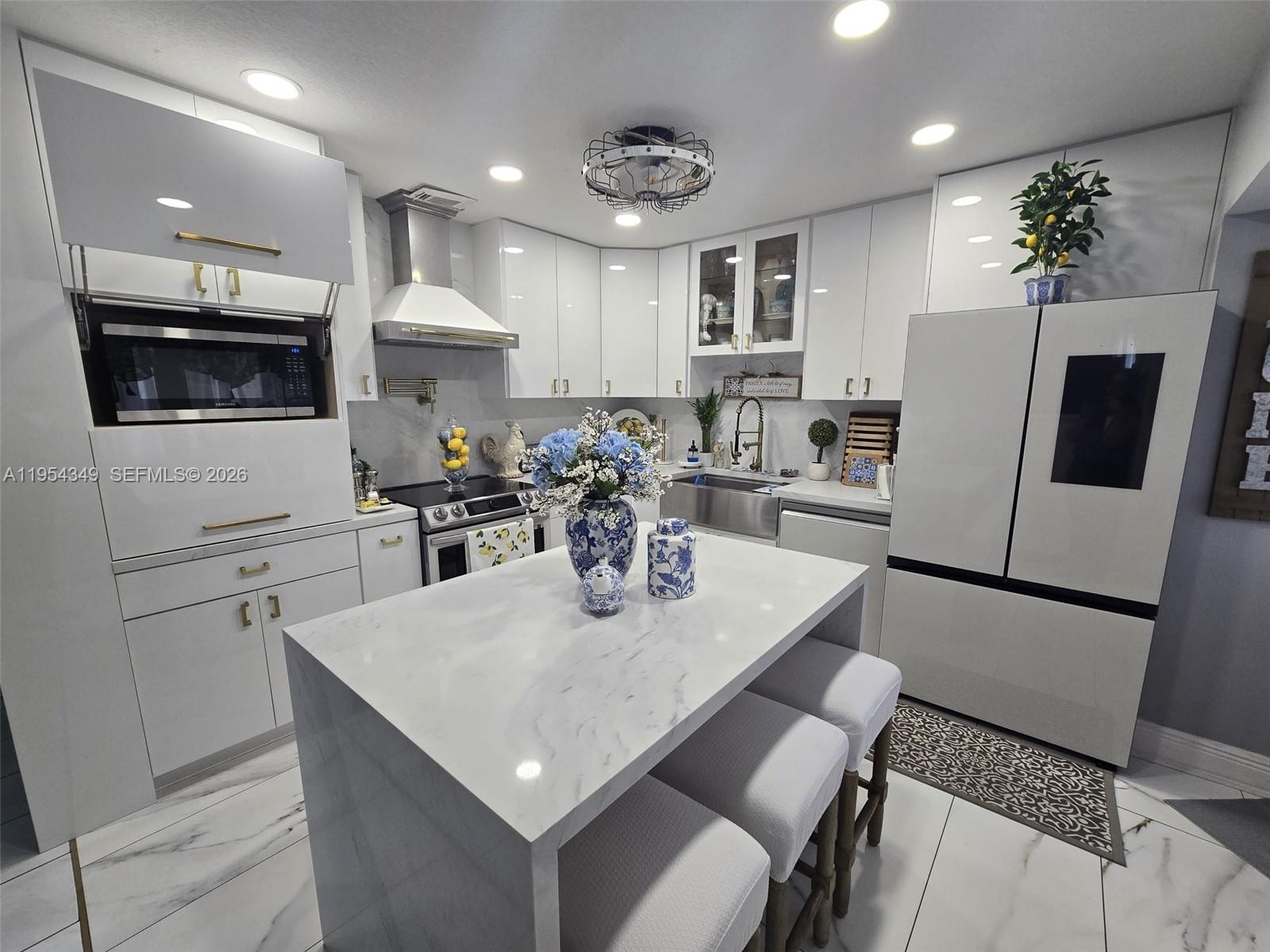 15201 Southwest 177th Terrace Miami, FL 33187 - Photo 28 of 49 a kitchen with white cabinets and refrigerator