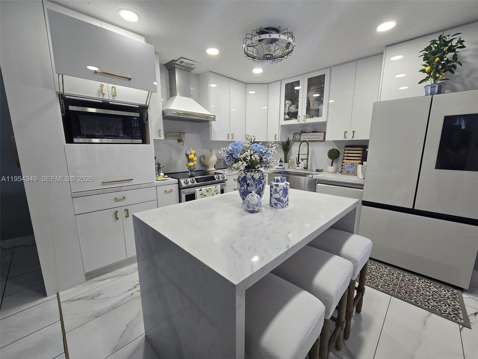15201 Southwest 177th Terrace Miami, FL 33187 - Photo 29 of 49 a kitchen with stainless steel appliances a sink a microwave a refrigerator and cabinets
