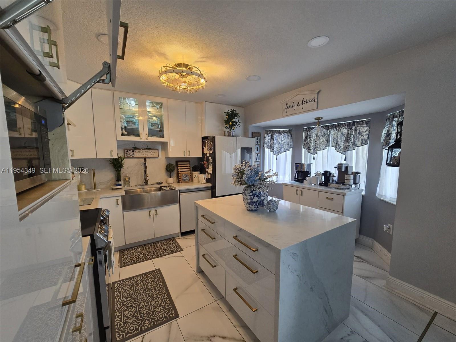 15201 Southwest 177th Terrace Miami, FL 33187 - Photo 30 of 49 a kitchen with sink cabinets and window