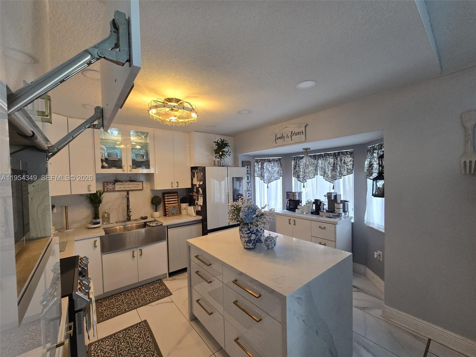 15201 Southwest 177th Terrace Miami, FL 33187 - Photo 31 of 49 a kitchen with a sink appliances and cabinets