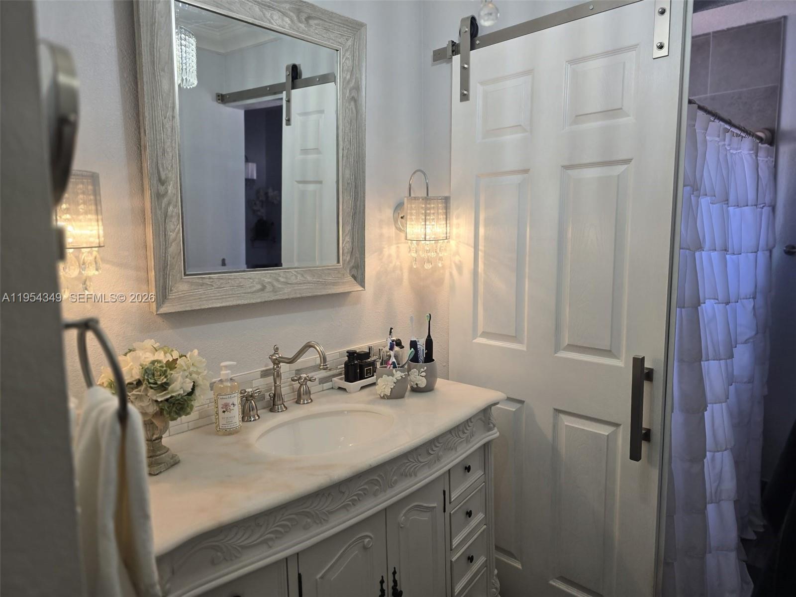 15201 Southwest 177th Terrace Miami, FL 33187 - Photo 36 of 49 a bathroom with a sink and mirror