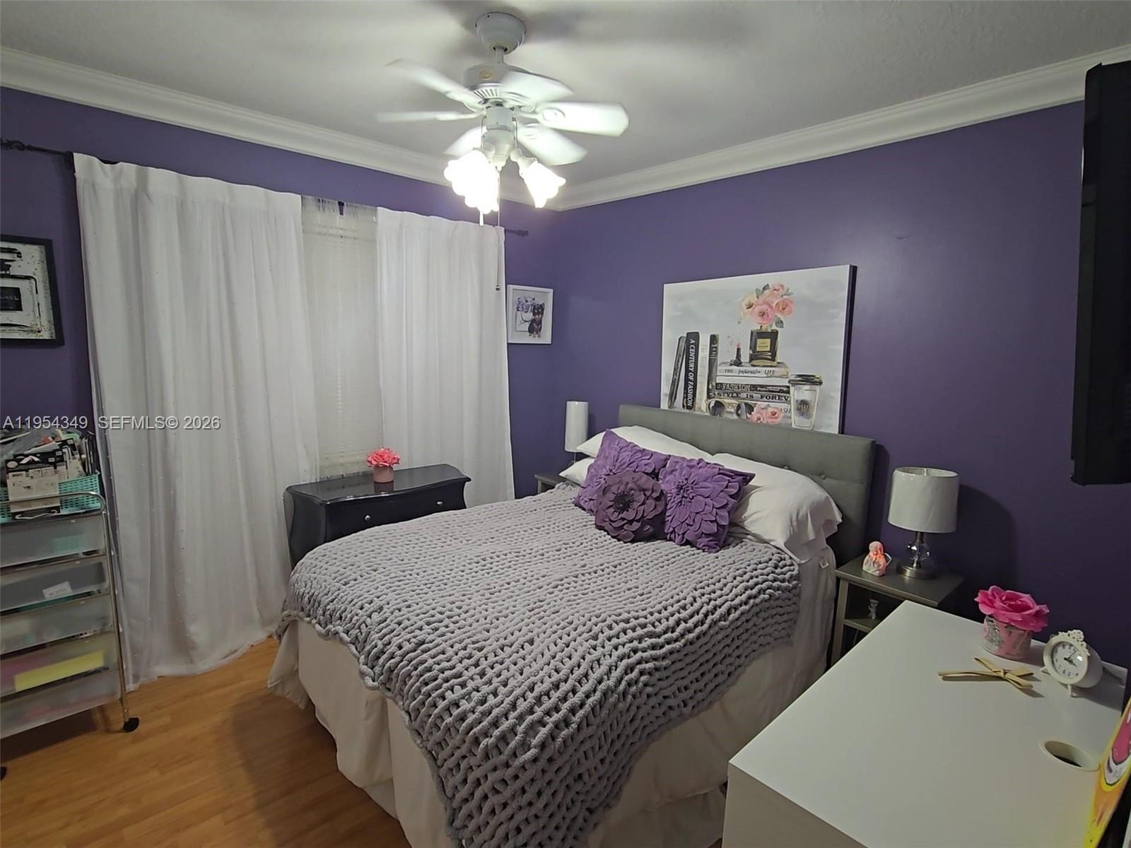 15201 Southwest 177th Terrace Miami, FL 33187 - Photo 38 of 49 a bedroom with a bed and a chandelier