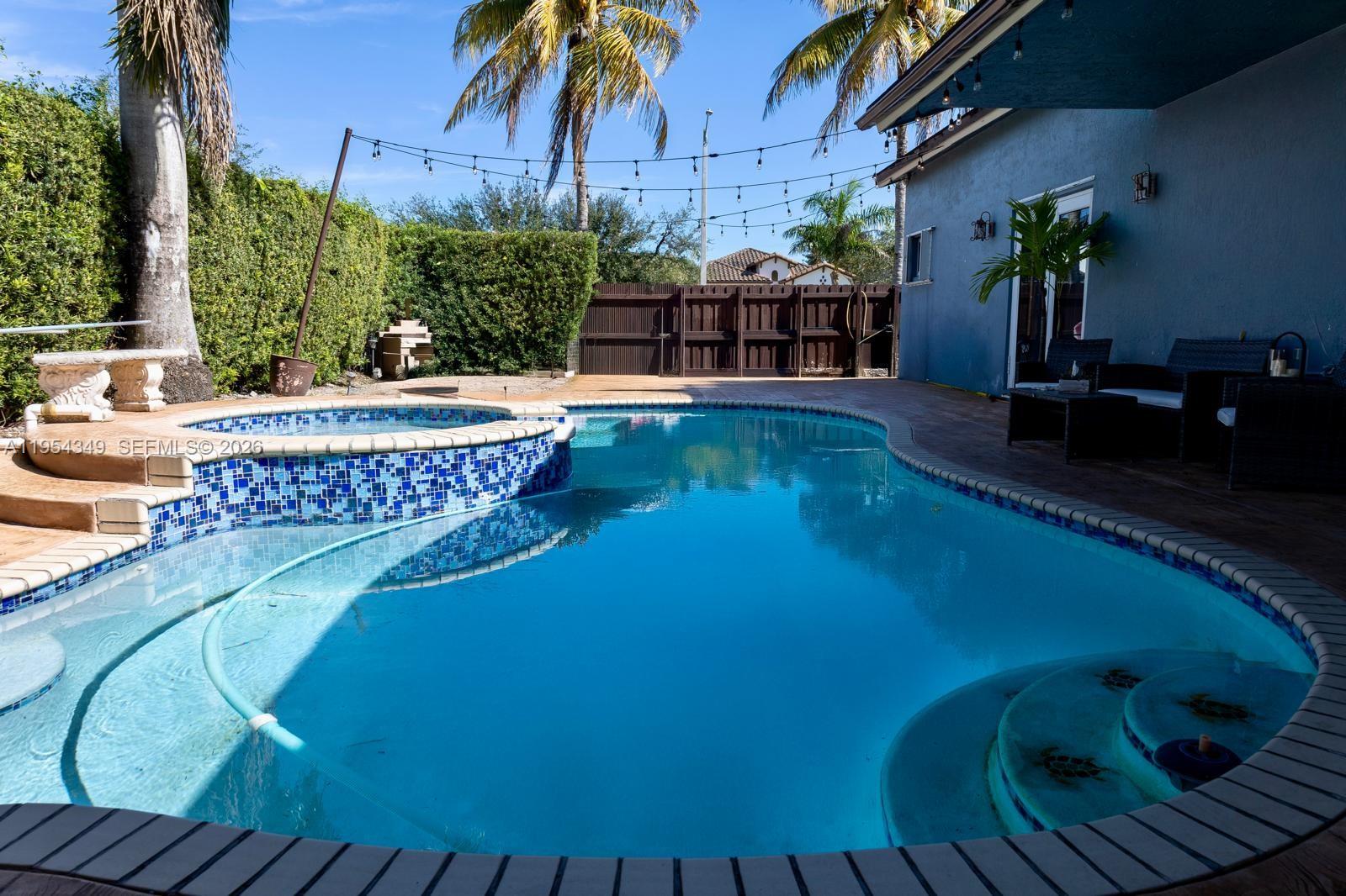 15201 Southwest 177th Terrace Miami, FL 33187 - Photo 48 of 49 a view of a swimming pool with a patio