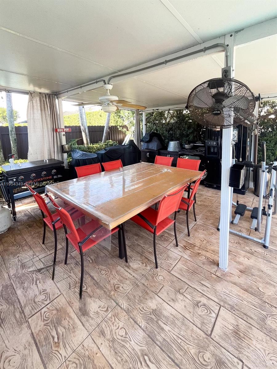 15201 Southwest 177th Terrace Miami, FL 33187 - Photo 49 of 49 a room with lots of tables a chandelier and pool table