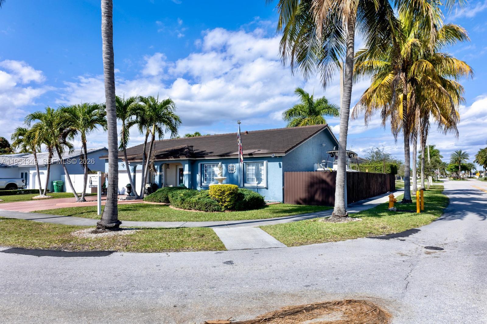15201 Southwest 177th Terrace Miami, FL 33187 - Photo 10 of 49 a front view of a house with garden and trees