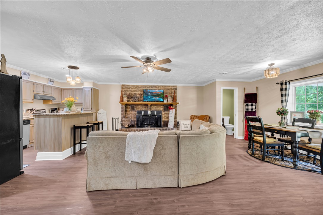 3030 Smith McGee Road Iva, SC 29655 - Photo 9 of 46 An inviting open-concept area combines living, dining, and kitchen spaces, perfect for gatherings.