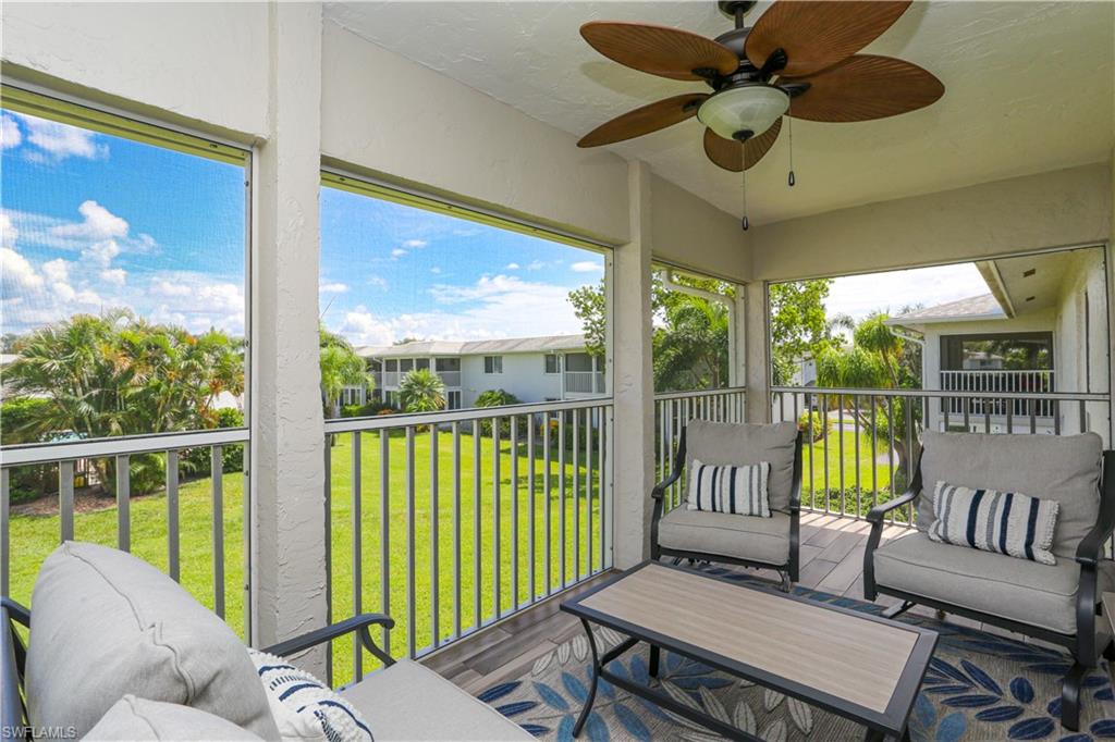 195 Peppermint Lane, Unit 884 Naples, FL 34112 - Photo 14 of 50 a living room with furniture and a large window