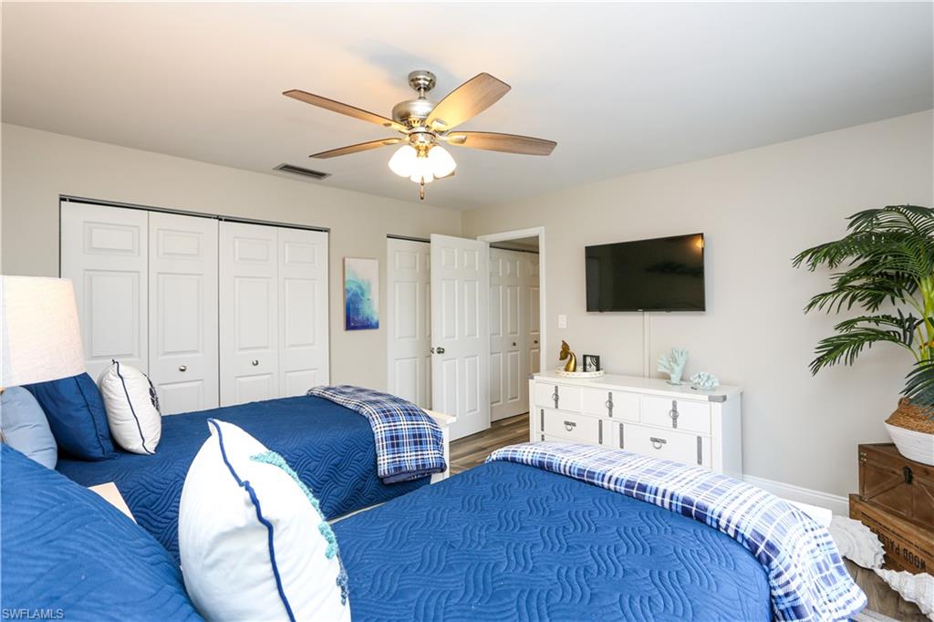 195 Peppermint Lane, Unit 884 Naples, FL 34112 - Photo 26 of 50 a bedroom with furniture and a flat screen tv