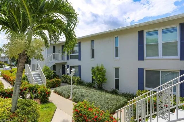a view of a hallway with wooden floor and closet