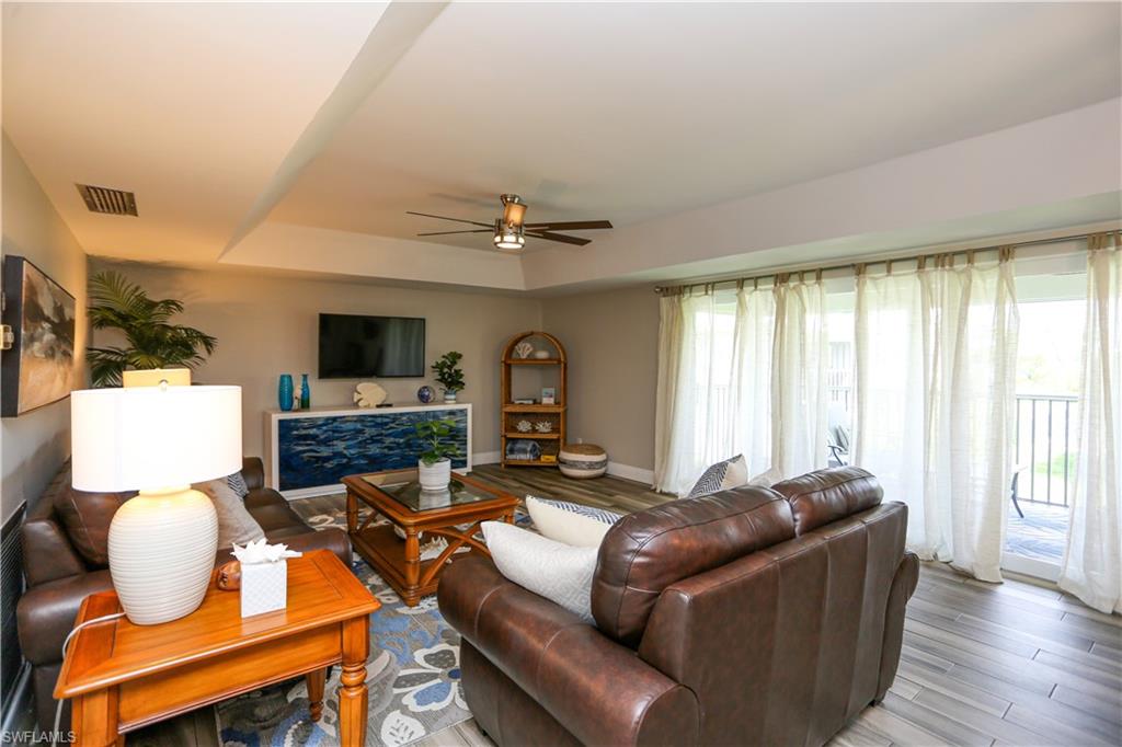 195 Peppermint Lane, Unit 884 Naples, FL 34112 - Photo 32 of 50 a living room with furniture fireplace and flat screen tv