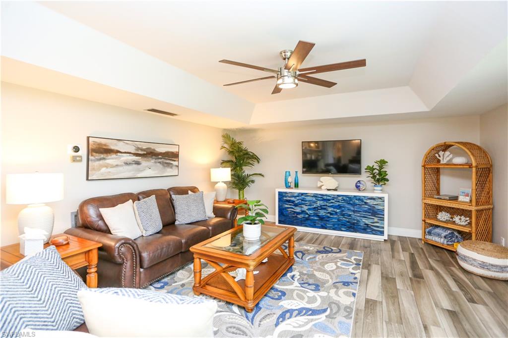 195 Peppermint Lane, Unit 884 Naples, FL 34112 - Photo 33 of 50 a living room with furniture and a flat screen tv
