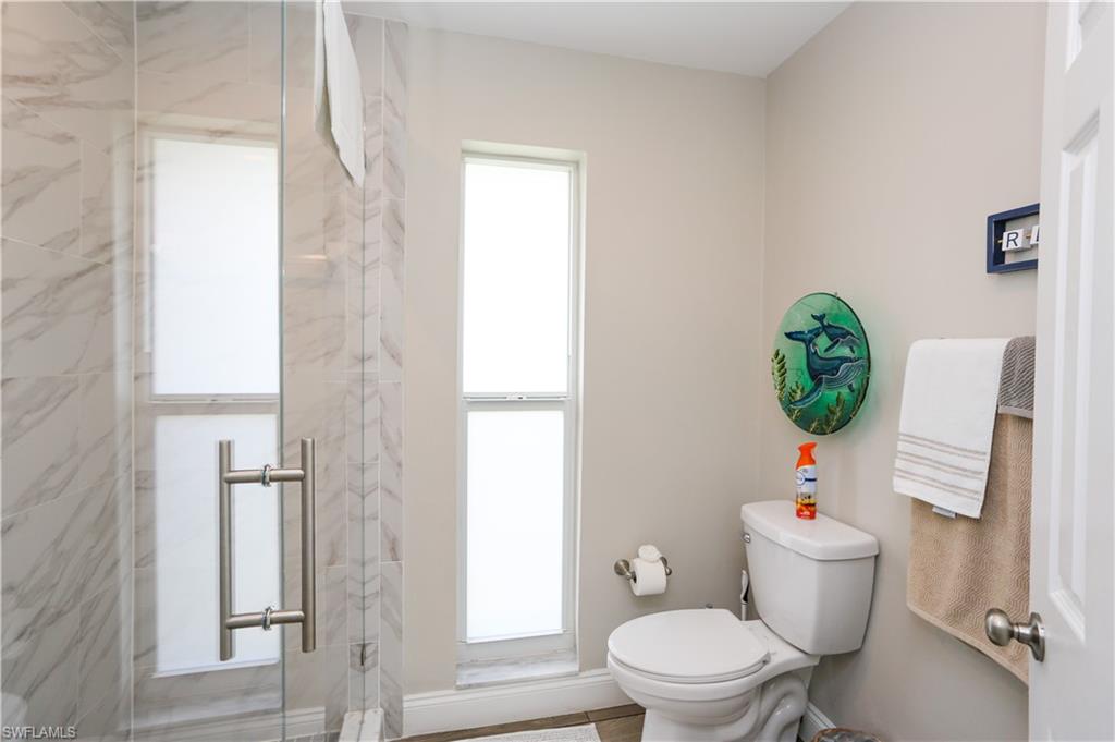 195 Peppermint Lane, Unit 884 Naples, FL 34112 - Photo 44 of 50 a white toilet sitting next to a shower curtain
