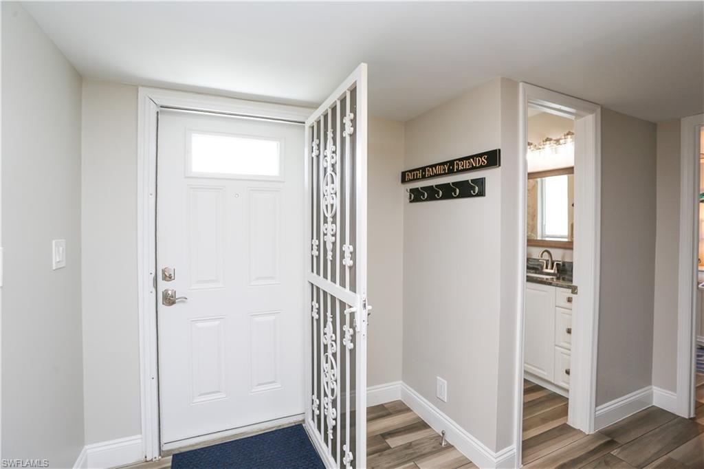 195 Peppermint Lane, Unit 884 Naples, FL 34112 - Photo 8 of 50 a view of a hallway with wooden floor and closet