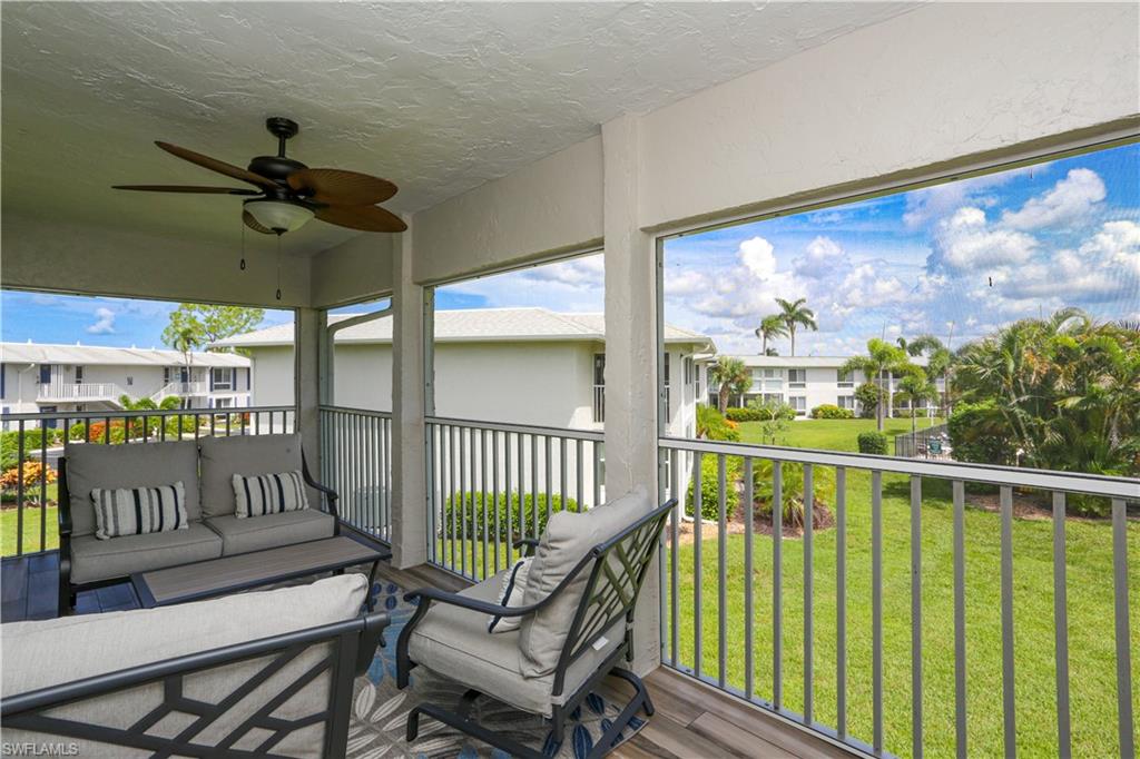 195 Peppermint Lane, Unit 884 Naples, FL 34112 - Photo 10 of 50 a view of a chairs and a table in the balcony