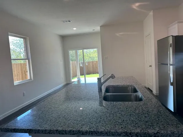 a kitchen with a sink and a refrigerator