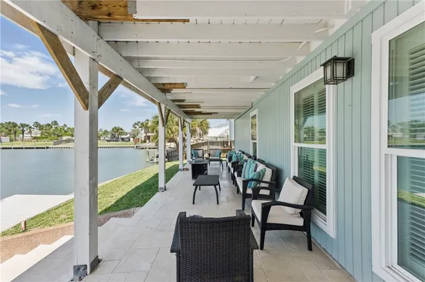 a view of a porch with chairs and backyard