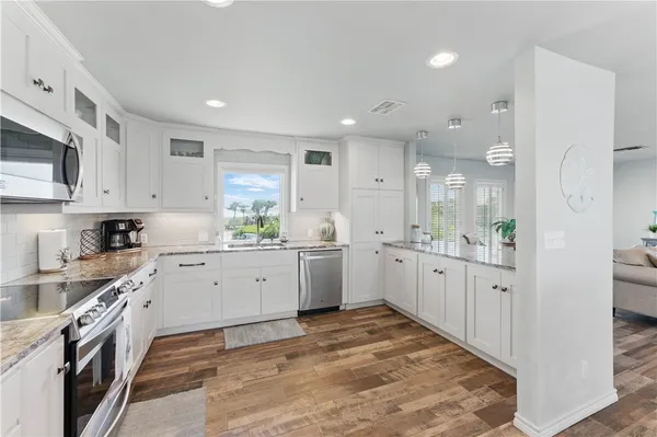 a kitchen with white cabinets and white appliances
