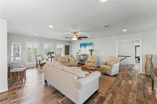 a living room with furniture and a wooden floor