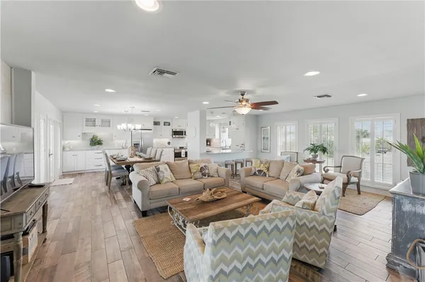 a living room with lots of furniture and kitchen view