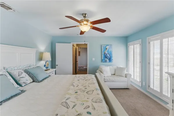 a bedroom with a large bed and a couch