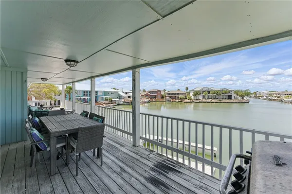 a view of a balcony with table and chairs