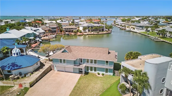 an aerial view of a house with a lake view