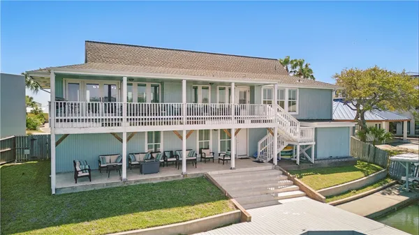 a view of a house with a backyard porch and sitting area