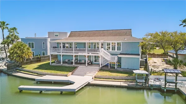 a view of a house with swimming pool and a chairs