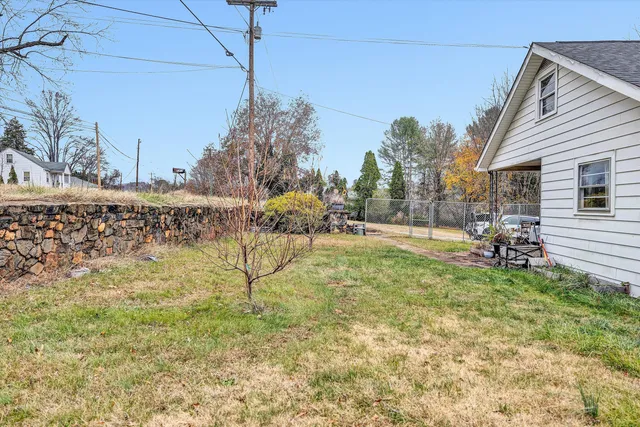 a backyard of a house with table and chairs