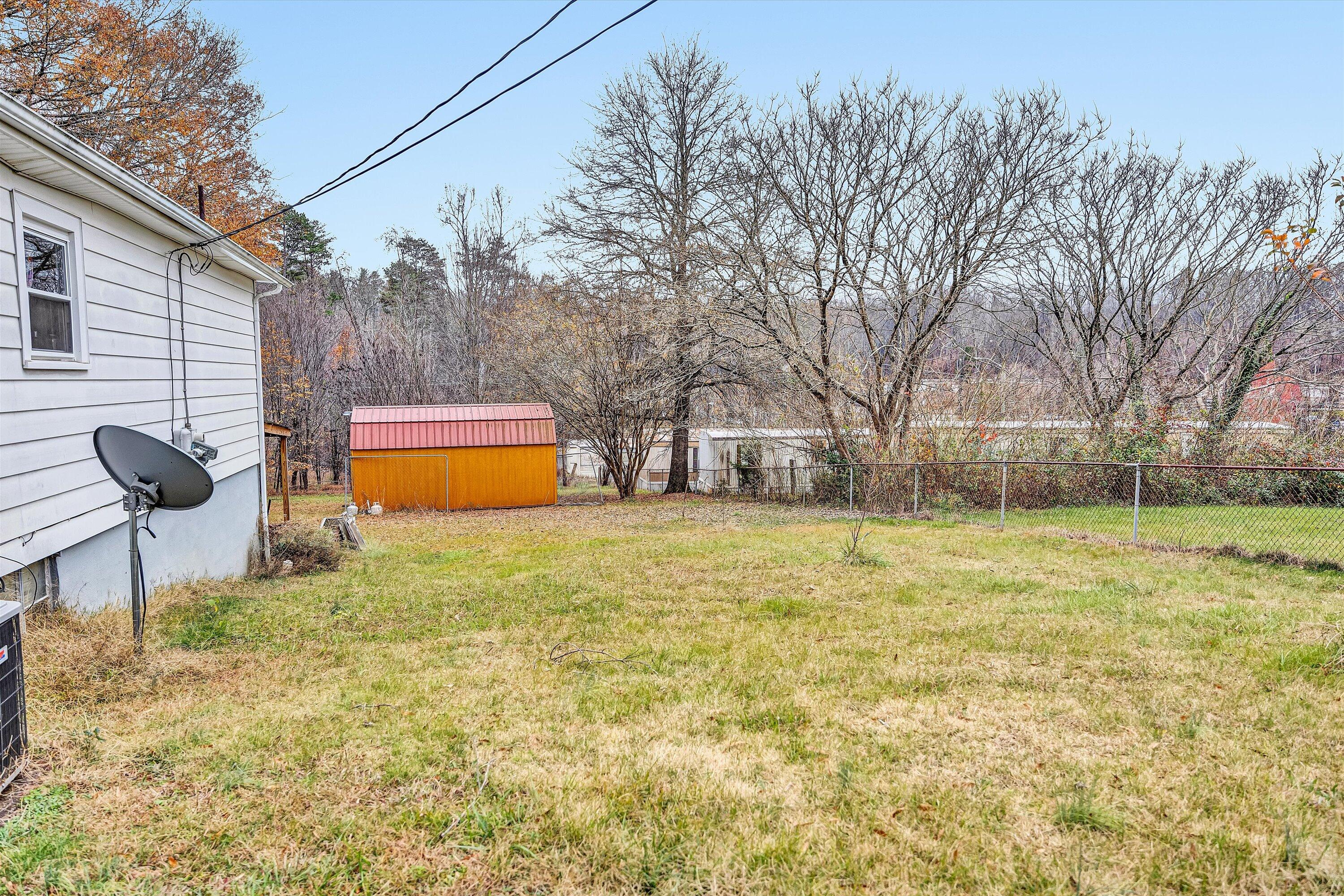 1414 Daniels Creek Road Collinsville, VA 24078 - Photo 13 of 17 a backyard of a house with table and chairs