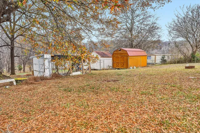 a view of a house with a patio and a yard