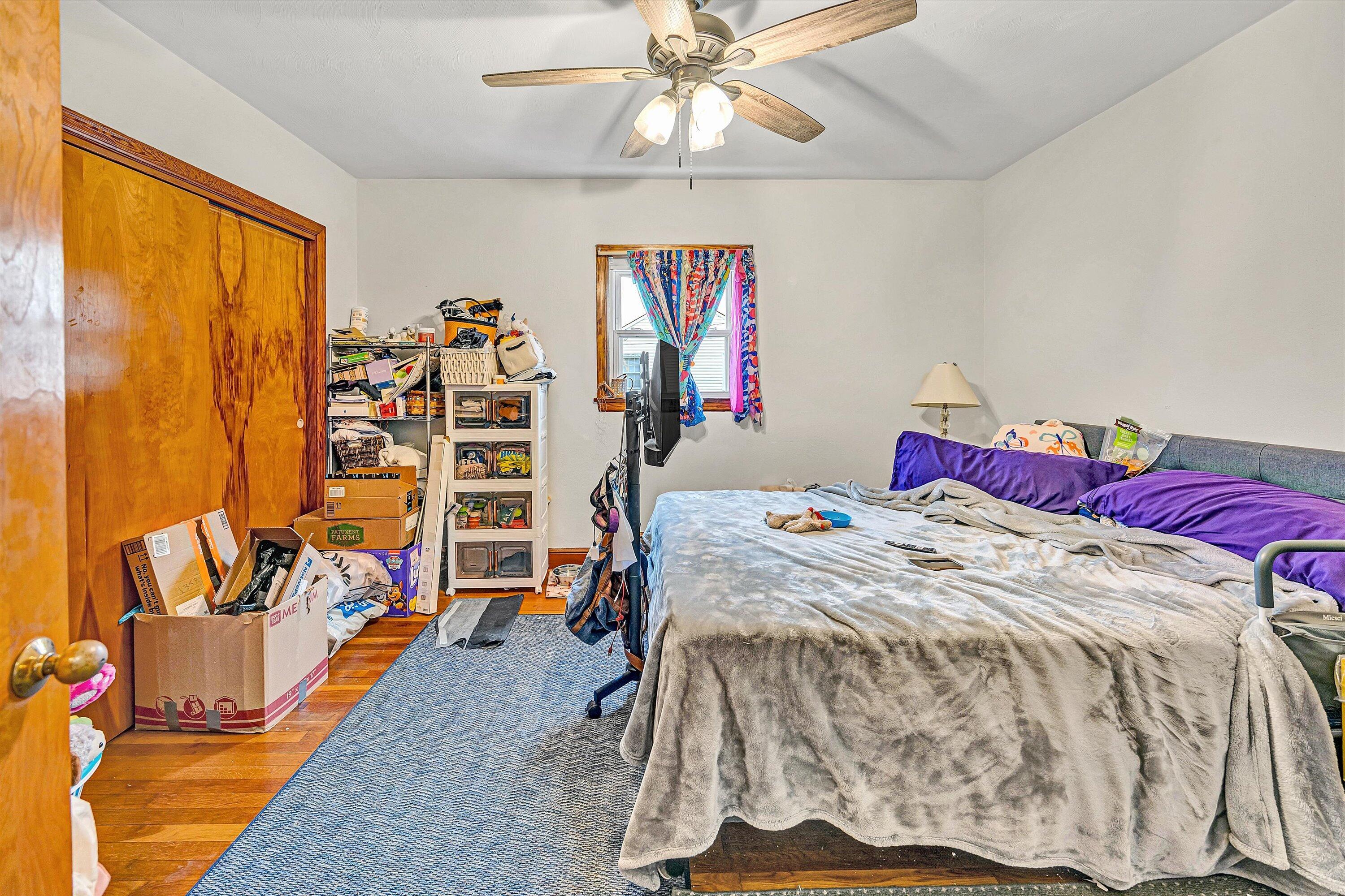 1414 Daniels Creek Road Collinsville, VA 24078 - Photo 9 of 17 a bedroom with a bed and a chandelier