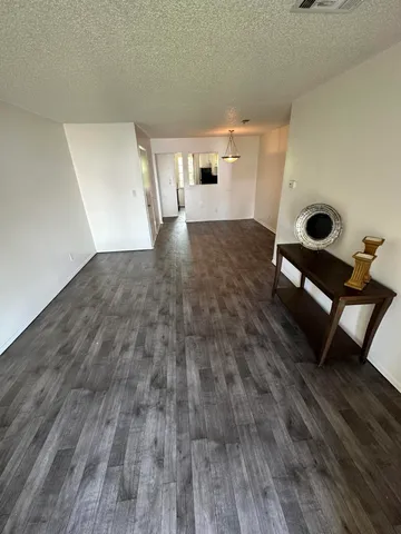 a room with wooden floor and furniture