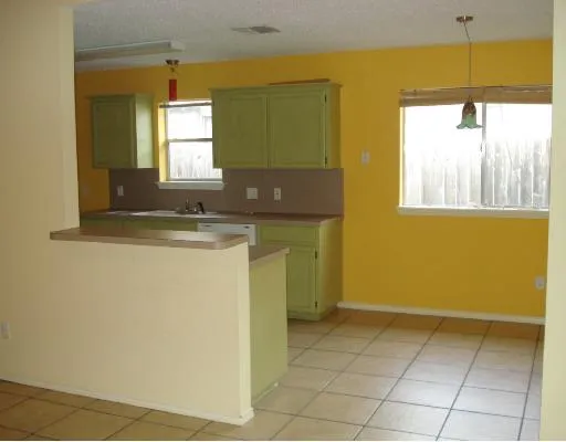 a view of a kitchen with a sink and a window
