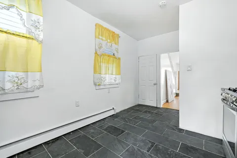 a view of an entryway with wooden floor and a bathroom