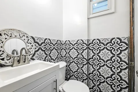 a bathroom with a sink a toilet and a mirror